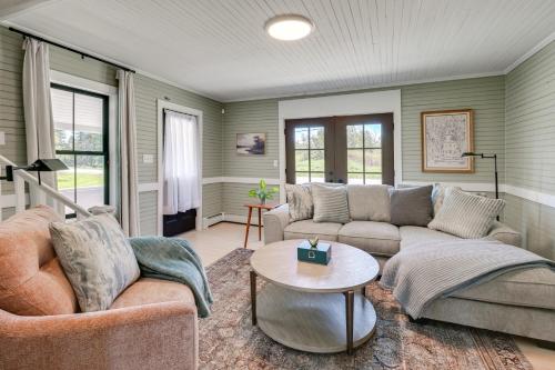 a living room with two couches and a table at Pond Views Spacious Family Home in Presque Isle! in Presque Isle