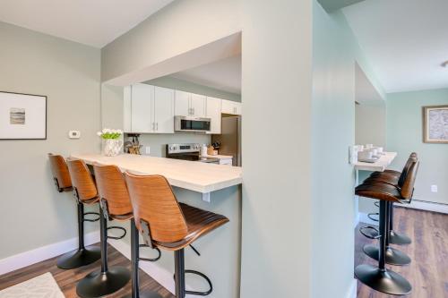a kitchen with a counter and stools in a room at Pond Views Spacious Family Home in Presque Isle! in Presque Isle