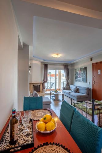 a living room with a table with fruit on it at Darina central Accommodation in Pefkochori