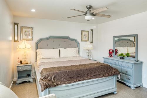 a bedroom with a bed and a mirror and a fan at 1 Mi to Rabobank Arena Home with Gazebo! in Bakersfield