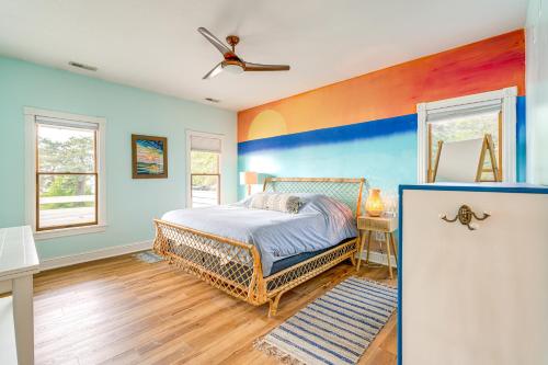 a bedroom with a bed and a ceiling fan at Hot Tub and Bay Views Outer Banks Home in Kill Devil Hills