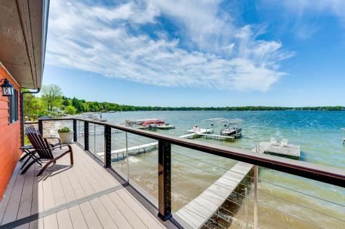 a balcony with a view of the water and boats at Steps to Powers Lake Wisconsin Family Home in Burlington