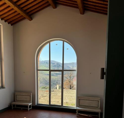 an arched window in a room with a view at Castello Vicchiomaggio in Greve in Chianti