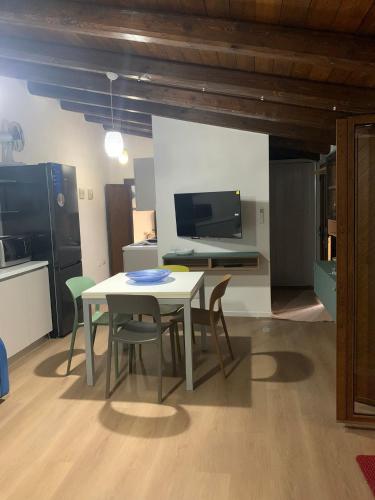 a dining room with a table and chairs and a tv at Villa Mia in Seneghe