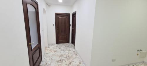 a hallway with two doors and a staircase in a room at Asmundo Palace Suites & Spa in Catania
