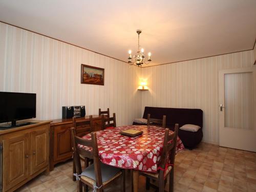 une salle à manger avec une table et une télévision dans l'établissement Appartement T2 avec balcon, parking et WIFI au Mont-Dore - FR-1-608-141, à Le Mont-Dore