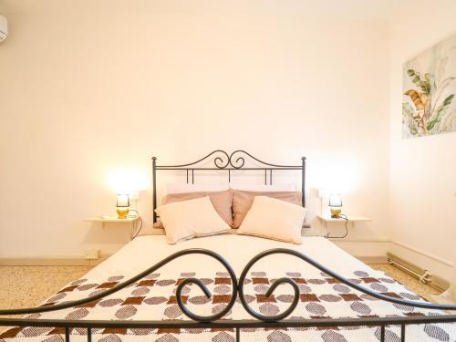 a bedroom with a bed with a wrought iron headboard at The Cozy Apartment - Wi-Fi, Smart TV, Free Parking in Montecatini Terme