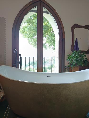 a large bath tub in a room with a window at That's amore - l'incanto della valle 