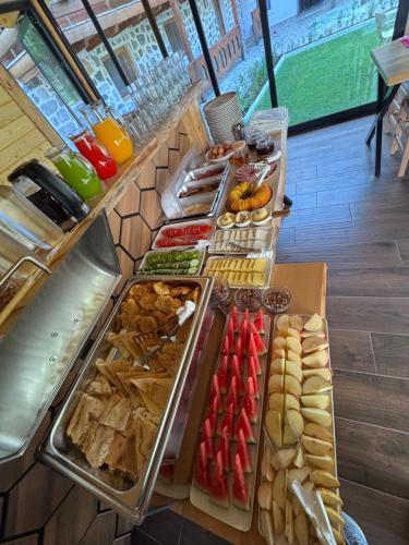 a buffet line with many different types of food at Guesthouse Prrockaj Theth in Theth