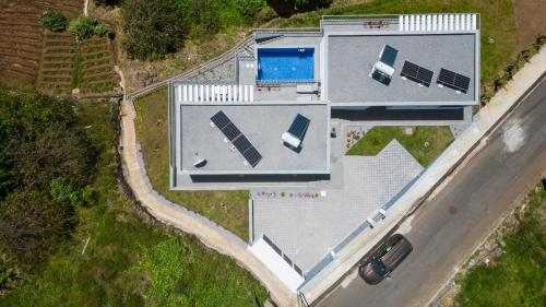 an overhead view of a house with a car at CASA PANORAMA SOL- NEW VILLA WITH HEATED SALTWATER POOL and FANTASTIC SEA VIEW in Ponta do Sol