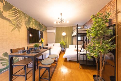 a living room with a couch and a loft bed at LEON RESORT HOTEL Makuhari & Tsudanuma Disney & Narita Airport Narashino by LEON RESORT 幕張 津田沼 習志野 in Narashino
