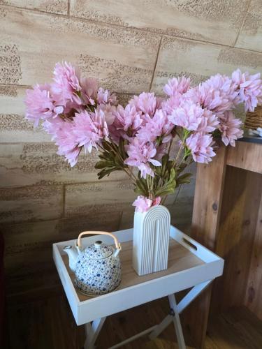 a vase of pink flowers sitting on a table at 3A vikendica Slankamen in Stari Slankamen