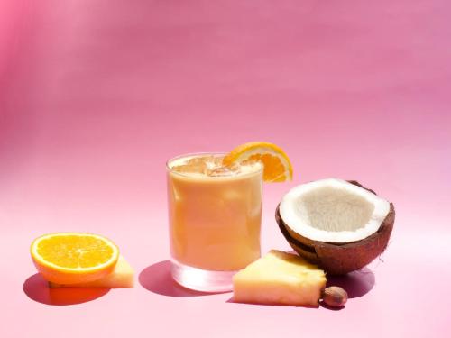a coconut and a glass of orange juice and an avocado at Tides Folly Beach, Charleston's Oceanfront Hotel in Folly Beach