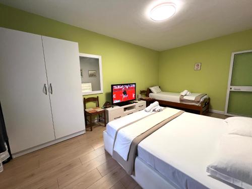 a bedroom with a bed and a tv in it at Downtown Retreat "Spiranca" in Tirana