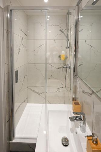 une salle de bain avec douche et lavabo dans l'établissement Serena, au Havre