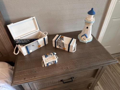 a table with a bottle and boxes on it at Twin Palms Motel in Titusville