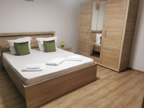 a bedroom with a large bed and a mirror at Lovely Apartment With Courtyard in Mangalia