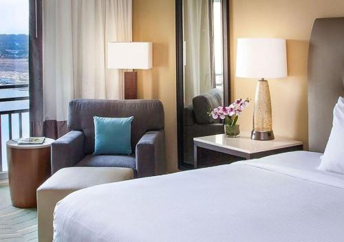 a hotel room with a bed and a chair at Lakeway Resort & Spa in Lakeway