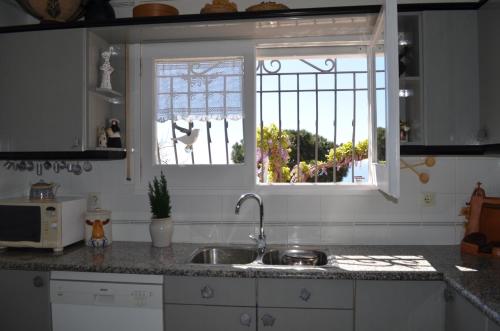a kitchen with a sink and a window at Villa Jordana Urbapol One Step To The Beach in San Pol de Mar