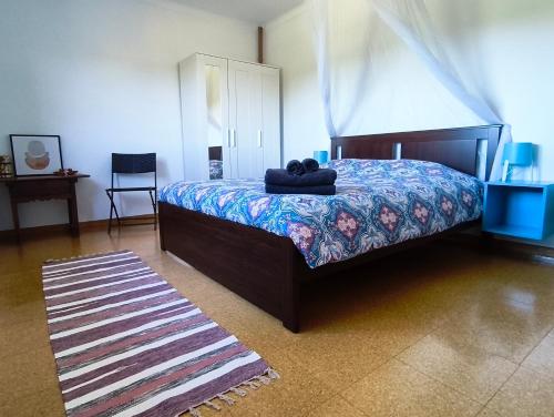 a bedroom with a bed with a teddy bear on it at Casa rural Chapinheira in Chapinheira