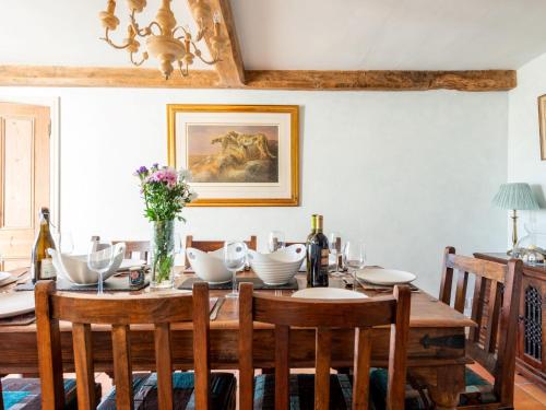 a dining room with a wooden table with chairs at 4 Bed in Gillingham 80670 in West Stour