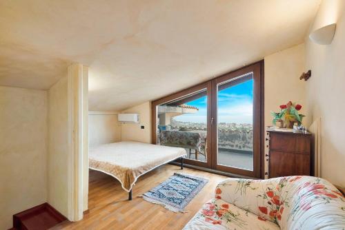 a bedroom with a bed and a large window at Piccolo Paradiso in Formia