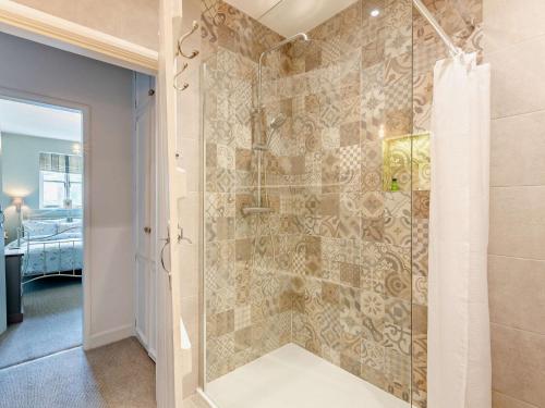 a bathroom with a shower with a glass door at 2 Bed in Kirkby Lonsdale 95452 in Kirkby Lonsdale