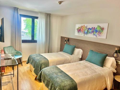 Postel nebo postele na pokoji v ubytování Hotel Ávila Diró