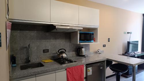 a kitchen with a sink and a stove top oven at Aparments Av La Paz in Arequipa
