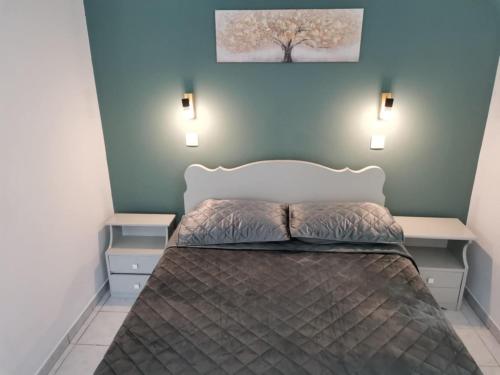 a bedroom with a bed with two night stands at Valentino's Apartment 2 in Panormos Kalymnos