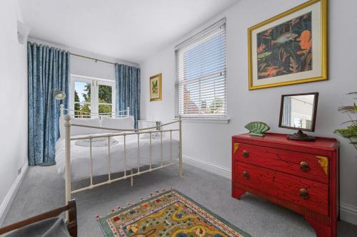 a bedroom with a bunk bed and a red dresser at 28 Church Ponds, Castle Hedingham in Castle Hedingham