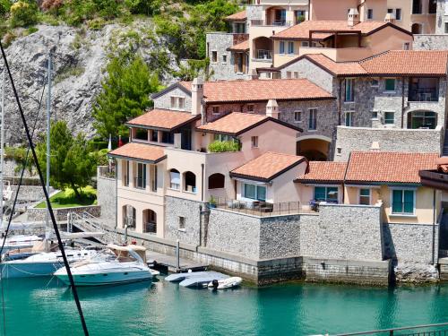 a group of houses and boats in the water at Portopiccolo Apartments in Sistiana