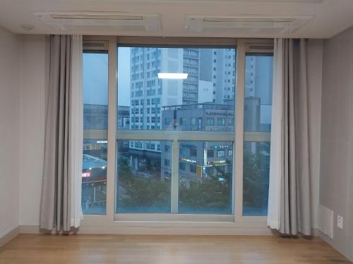 a large window with a view of a city at Giheung Station Lotte Castle in Yongin