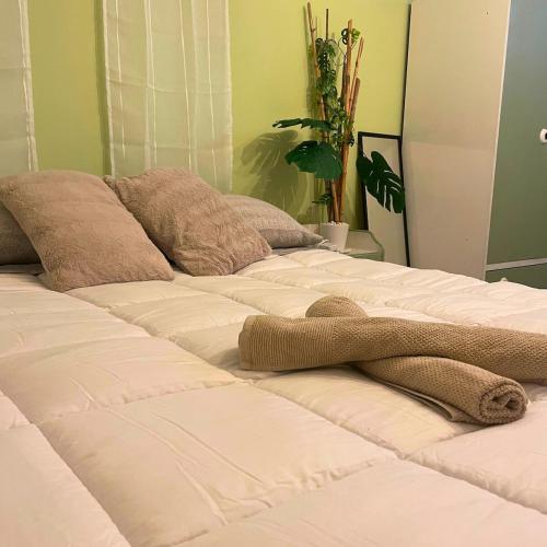 two beds with a stuffed animal on top of them at Paola's Garden in Carbonia