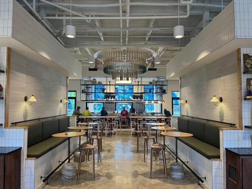 a restaurant with tables and chairs and a chandelier at OS Hotel in Ocean Springs