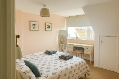 a bedroom with a bed with blue pillows on it at Renas Seahaven Cottage in Cullercoats