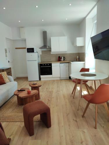 un salon avec une table et une cuisine dans l'établissement CMG Studio 102 XL Petit-Bois Place Ducale, à Charleville-Mézières