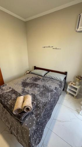a bedroom with a bed with two towels on it at Suítes da Orla Hospedagens in Arraial do Cabo