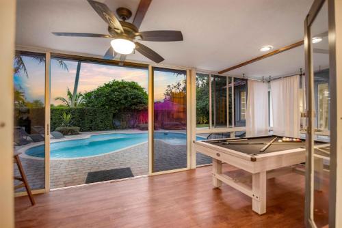 a room with a pool table and a ceiling fan at Firepit, Beach, Basketball, LuxuryVilla in Palmetto Bay