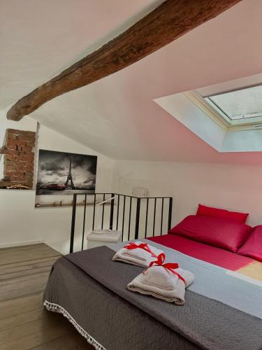 a bedroom with a bed with red pillows and a window at Ca' del Grillo in La Spezia