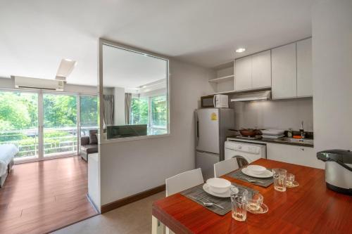 a kitchen and dining room with a table and chairs at Story At Bangkok- 211 Studio with Balcony in Klong Toi