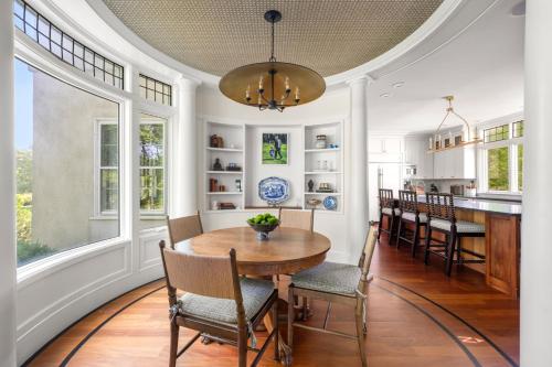 a dining room with a table and chairs at Lavish Boston Mansion Pool, Gardens, Games, Pond! in Dedham