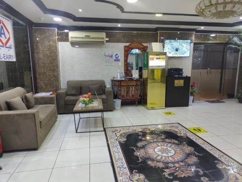 a living room with couches and a table and a rug at شركة العييري للشقق المخدومة الدمام 4 Al-Ayeri Serviced Apartments Company Dammam in Dammam