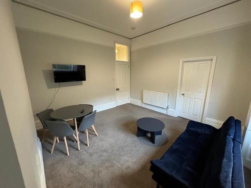 a living room with a couch and a table at Charming apartment Belsize Park in London