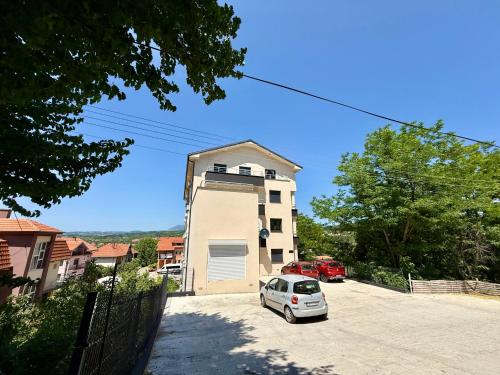 a white car parked in front of a building at Tajna Ozrena - Sokobanja in Soko Banja