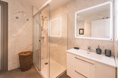 a bathroom with a shower and a sink and a mirror at Ático Green Life by Solset in Vélez-Málaga