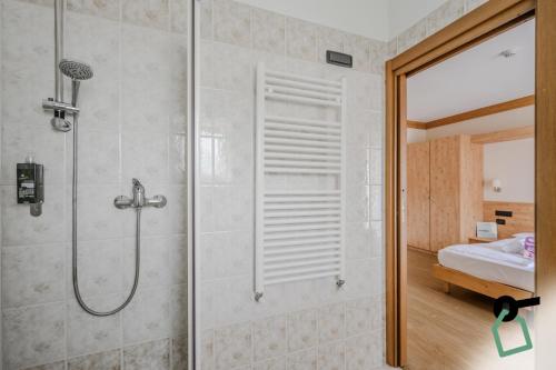 a shower with a glass door in a bathroom at Hotiday Bormio Valdidentro in Bormio