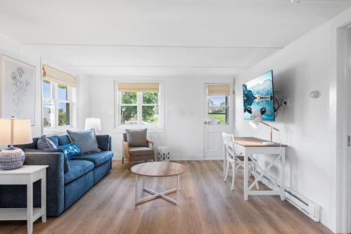 a living room with a blue couch and a table at Marina Bay Cottages in Waterford