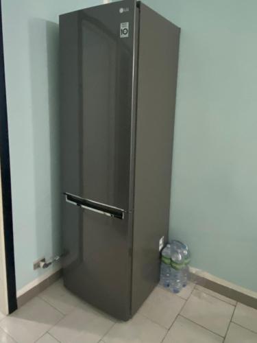 a stainless steel refrigerator in the corner of a room at Casa Josto a due passi da Spiaggia Maladroxia in Maladroxia