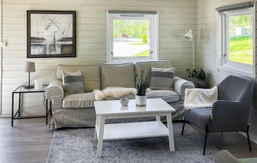 a living room with a couch and two chairs and a table at 2 Bedroom Stunning Home In Lavik in Lavik